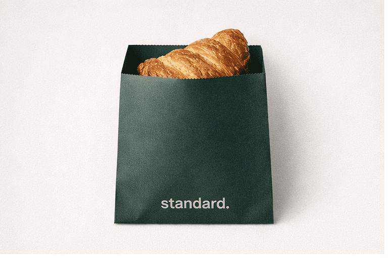 Forest green pastry bag holding a butter croissant